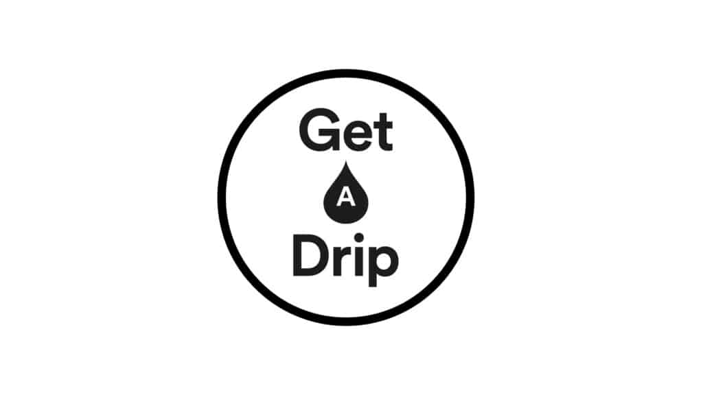 A black circle encloses the words “Get Drip,” with “Get” on top and “Drip” at the bottom. Centered is a black water droplet featuring a white “A,” forming the phrase “Get A Drip,” inspired by IV Vitamin Therapy, on a plain white background.